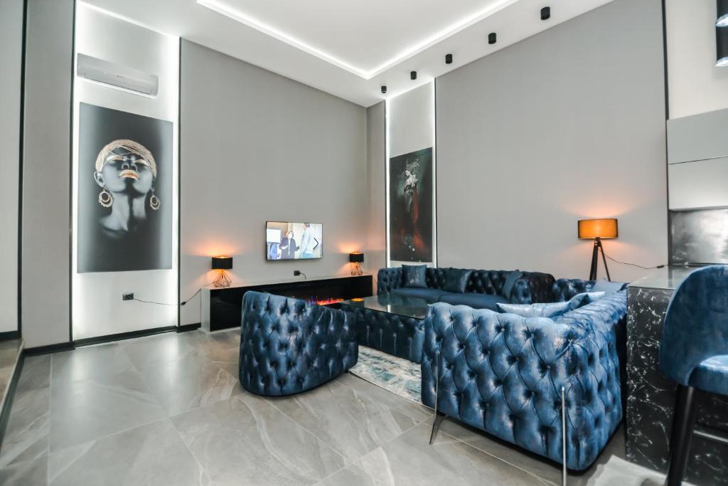 a living room with blue chairs and a couch at VIP APARTMENT FRANCE EMBASSY in Baku