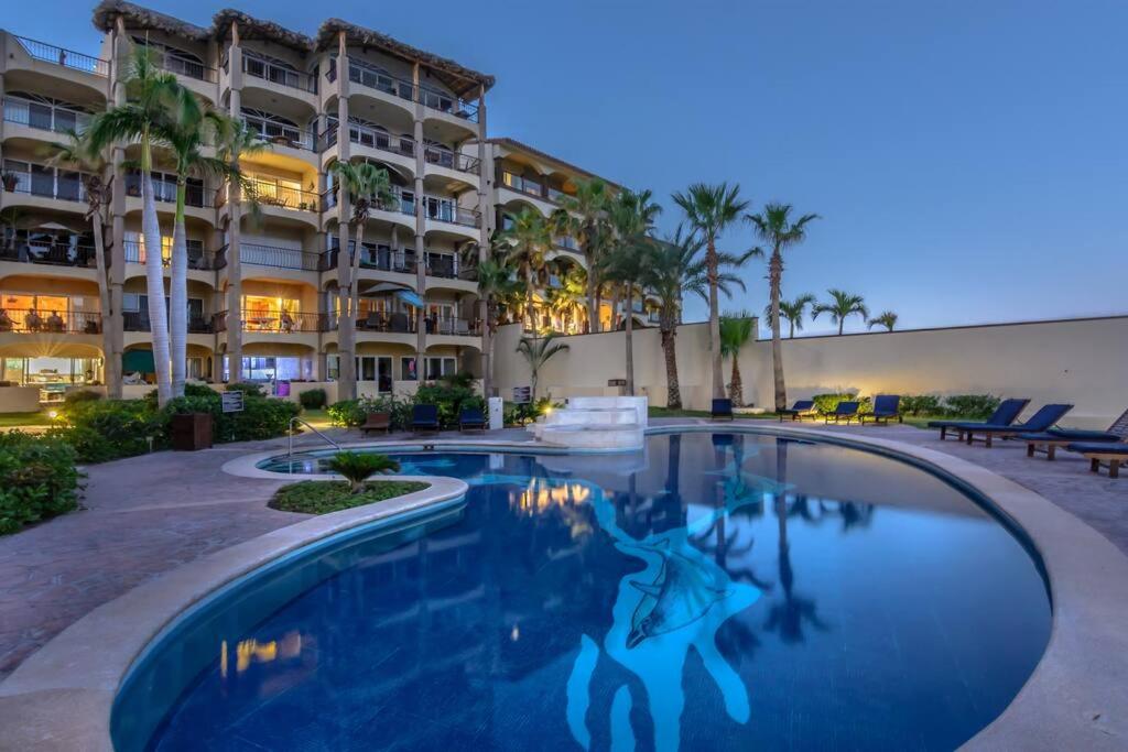 a swimming pool in front of a building at Sub- Penthouse Las Olas Surfers Paradise in San José del Cabo