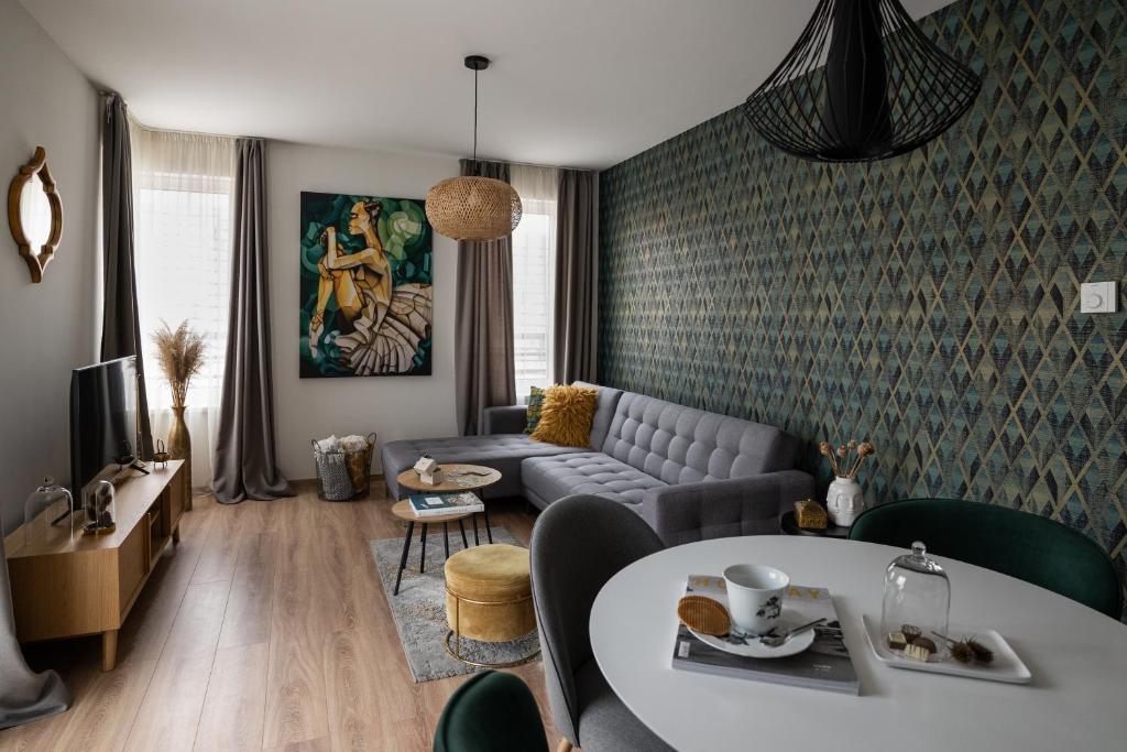 a living room with a couch and a table at Cesar Apartman in Sopron