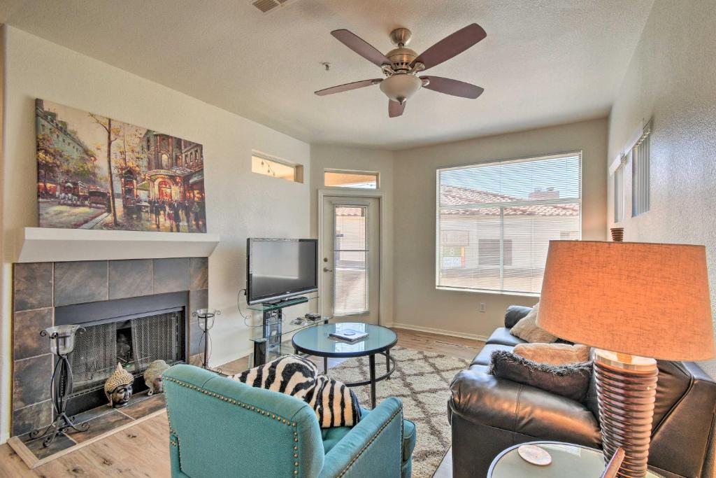 a living room with a couch and a fireplace at Tranquil Scottsdale Condo with Community Pool! in Scottsdale