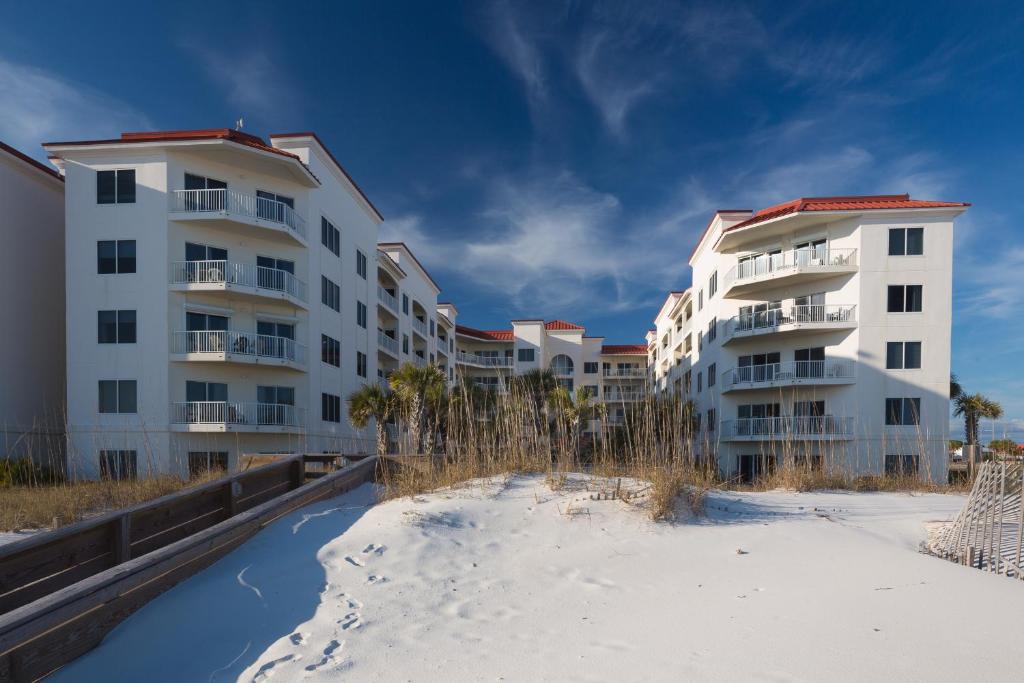 a row of apartment buildings on the beach at Palm Beach Resort Orange Beach a Ramada by Wyndham in Orange Beach