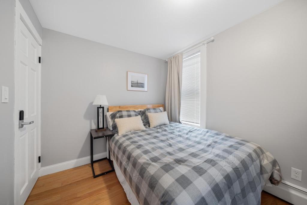 a bedroom with a bed and a window at Easy Commute South Boston 4BR 1BH Apt in Boston