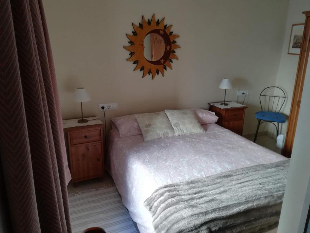 a bedroom with a bed and a mirror on the wall at Casa Vista in Alcalá de los Gazules