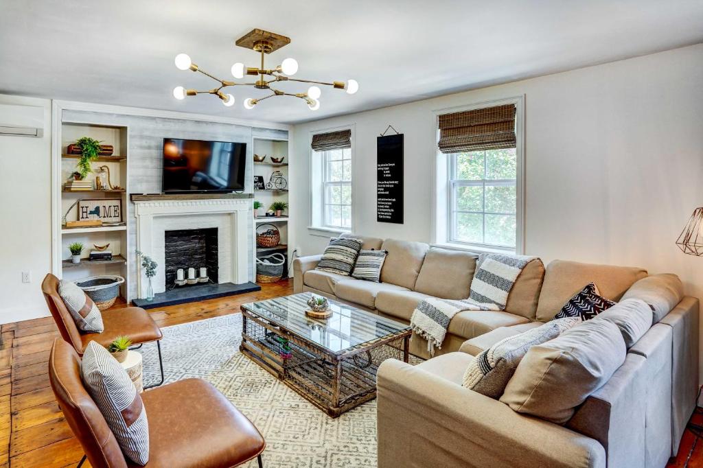 a living room with two couches and a fireplace at Chic Troy Home Near Downtown, 9 Mi to Albany! in Troy