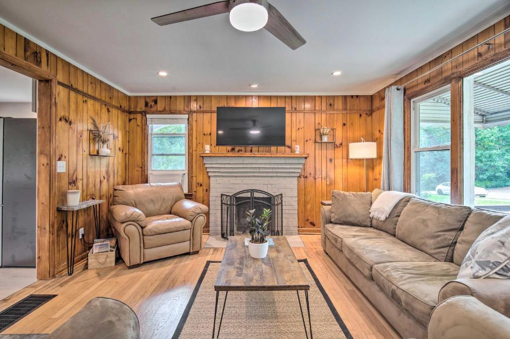 a living room with a couch and a fireplace at Cozy Arden Cottage, 2 Mi to Lake Julian Park! in Arden