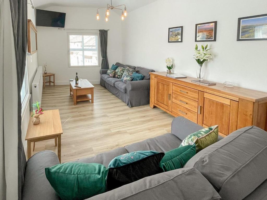 a living room with a couch and a table at Derwent Apartment in Glossop