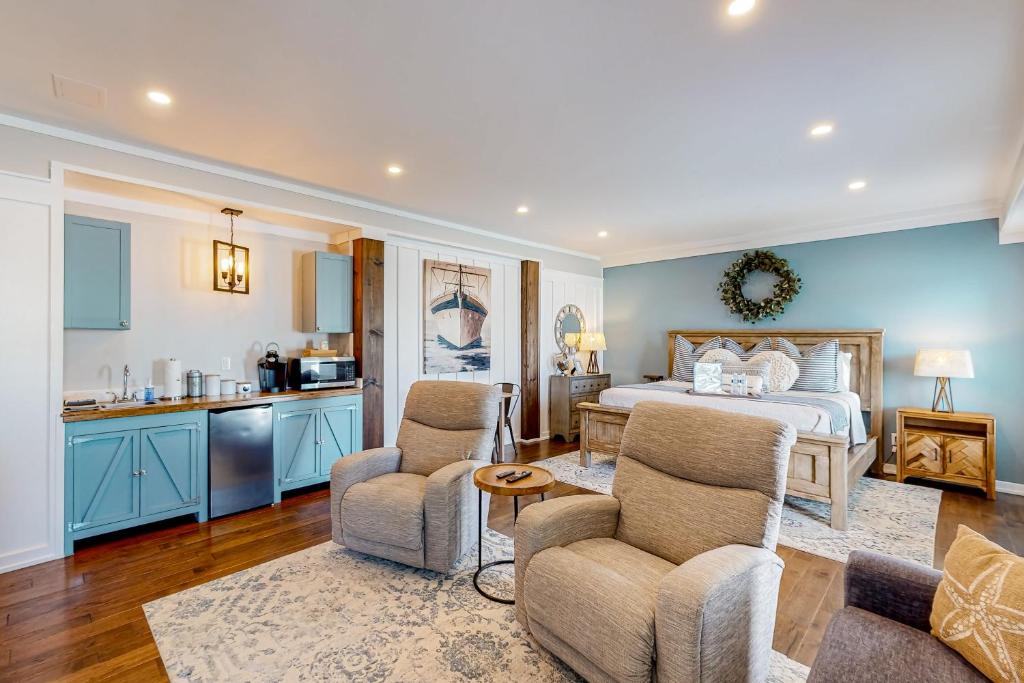 a living room with a bed and a kitchen at Coastal Haven - Unit C - Downstairs in Kill Devil Hills
