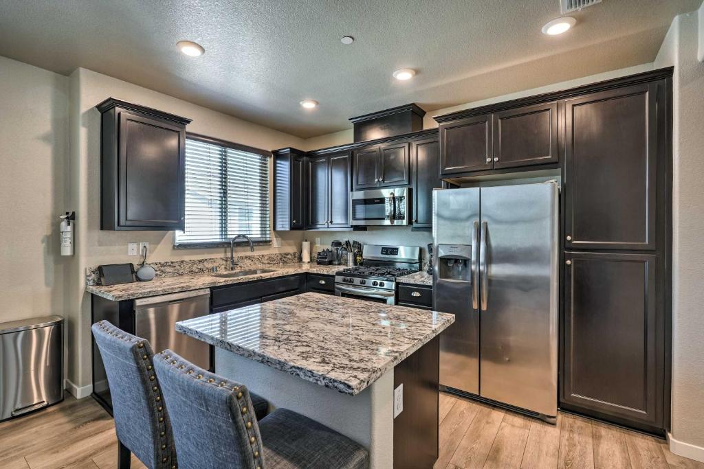 a kitchen with stainless steel appliances and wooden cabinets at Pet-Friendly Elk Grove Retreat w/ Balcony! in Elk Grove