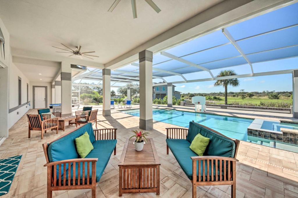 an outdoor patio with a pool and tables and chairs at Sprawling Fort Denaud Paradise Pool, Hot Tub in La Belle