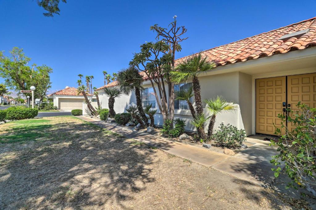 a house with a driveway and a garage at Furnished Patio and Pool Access Palm Desert Home! in Palm Desert
