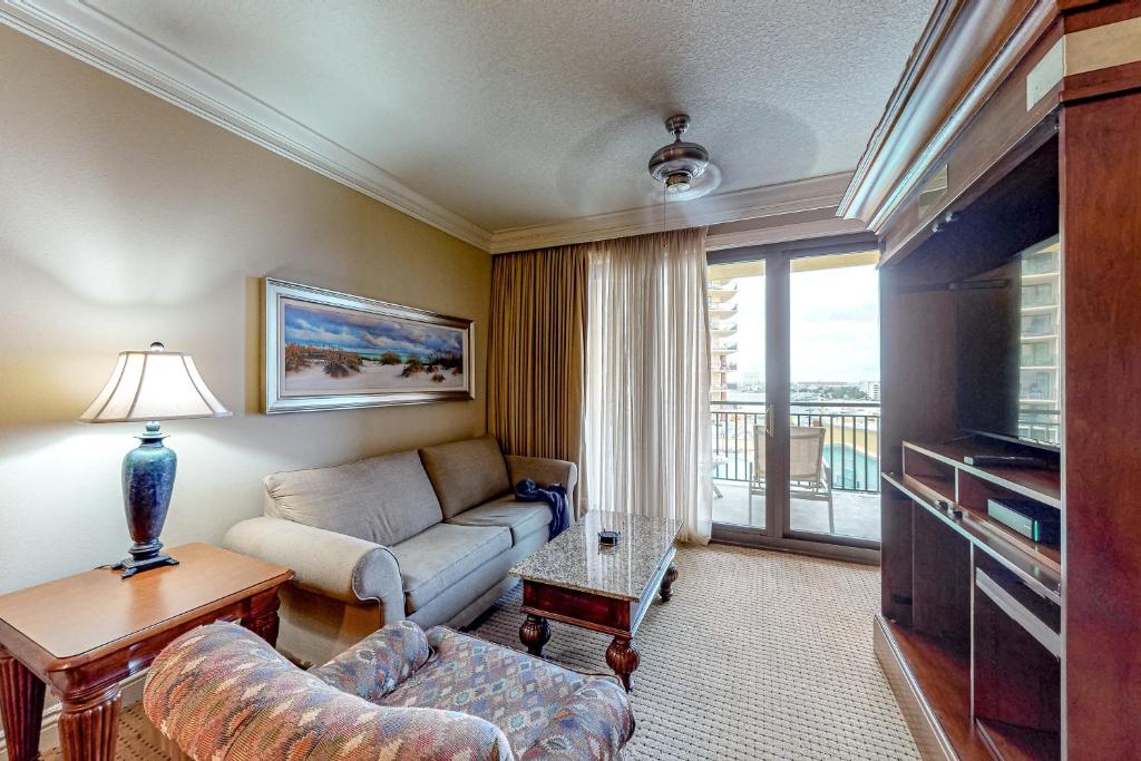 a living room with a couch and a tv at Emerald Grande 324 in Destin