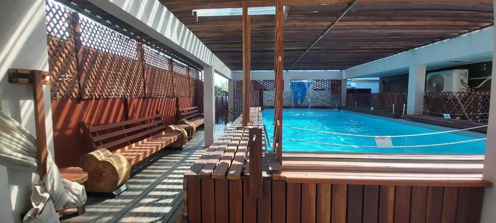 une grande piscine entourée de bancs dans l'établissement Waterland Suites, à Paramaribo