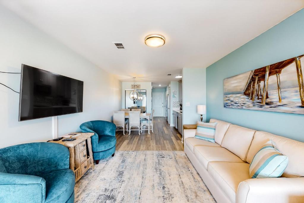 a living room with a couch and a tv at Sunset Harbor Palms 2-108 in Navarre