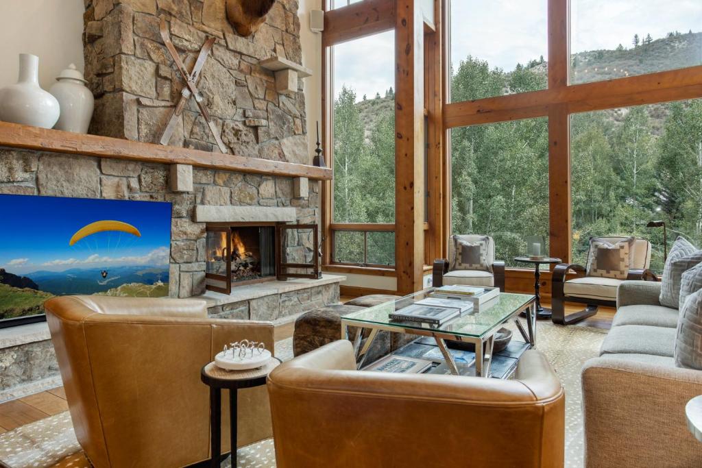 a living room with a fireplace and a stone wall at 358 Cresta Road in Edwards