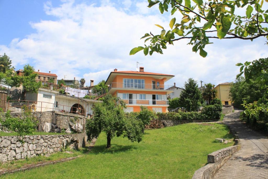 a house in the middle of a green yard at Apartments with a parking space Opatija - Pobri, Opatija - 7918 in Volosko