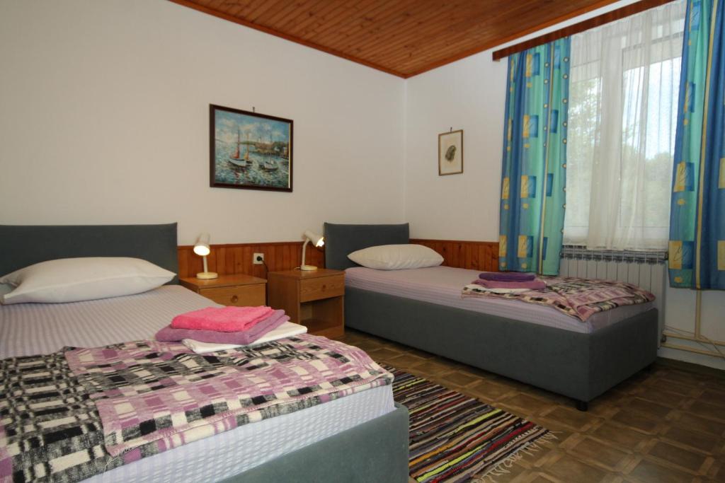 Posteľ alebo postele v izbe v ubytovaní Apartments and rooms by the sea Mali Losinj (Losinj) - 7953
