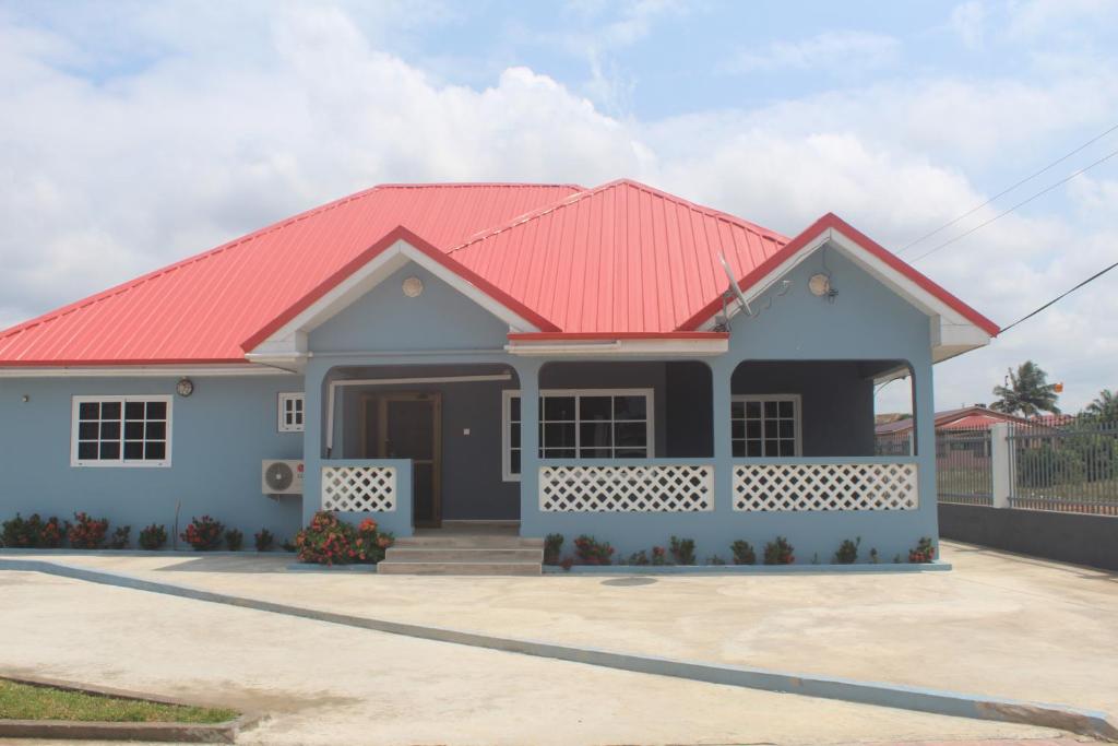 a house with a red roof at Coast to Coast Vacation Home in Winneba