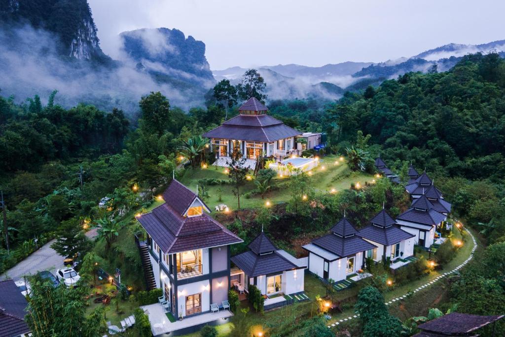 an aerial view of a house in the mountains with lights at Magical Mountain View Resort in Khao Sok National Park