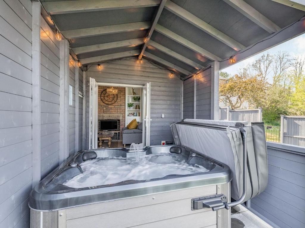 a jacuzzi tub sitting inside of a house at Spa Cottage in Bakewell