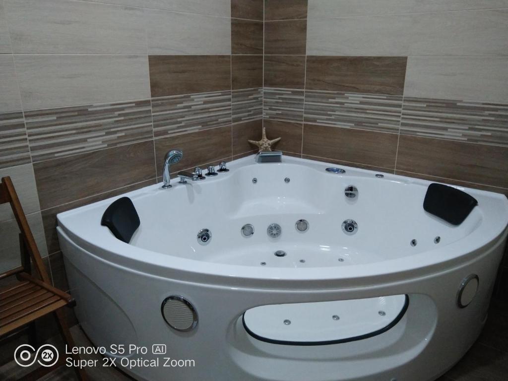 a bath tub with a faucet in a bathroom at Apartmán s vířivkou a infrasaunou v Olomouci in Olomouc