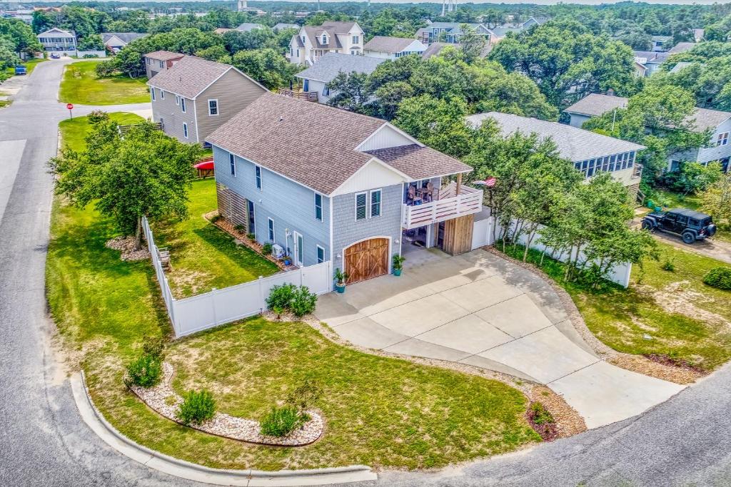 an aerial view of a house with a driveway at Coastal Serenity - Unit A - Top Floor in Kill Devil Hills