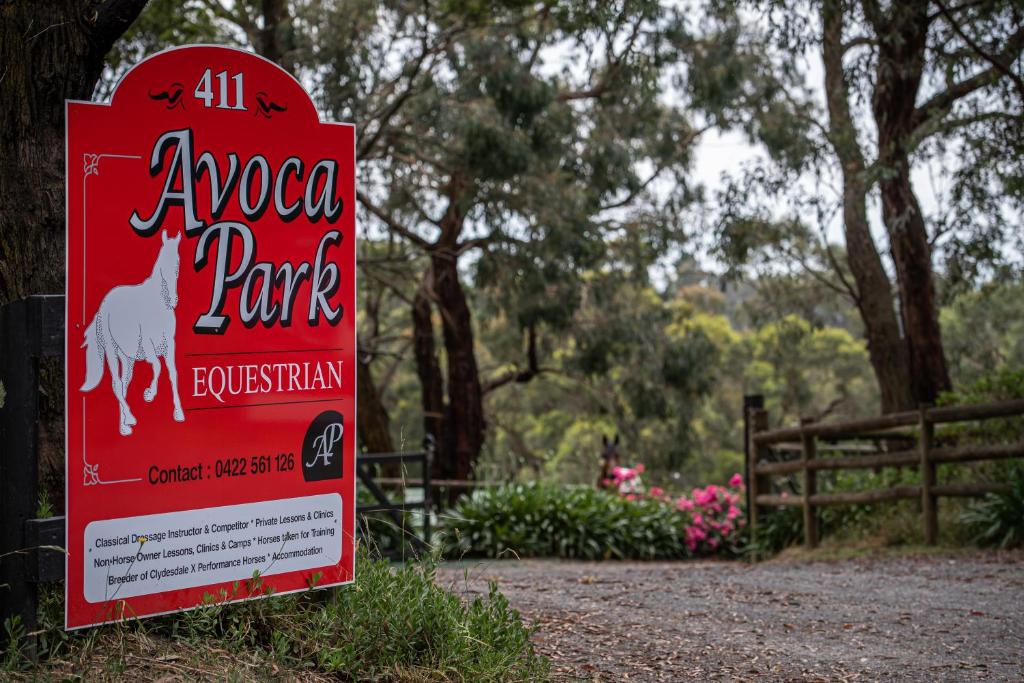 a sign for a park with a white goat on it at Avoca Park Equestrian Farmstay in Macclesfield