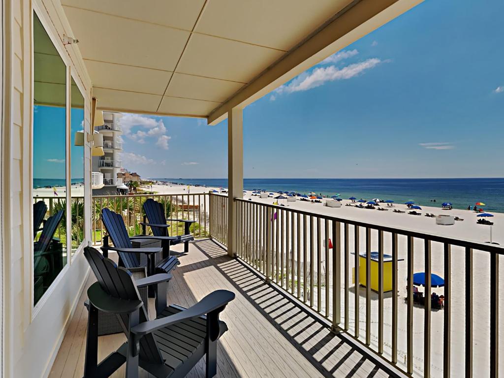 a balcony with chairs and a view of the beach at Sea Glass #201 in Gulf Shores