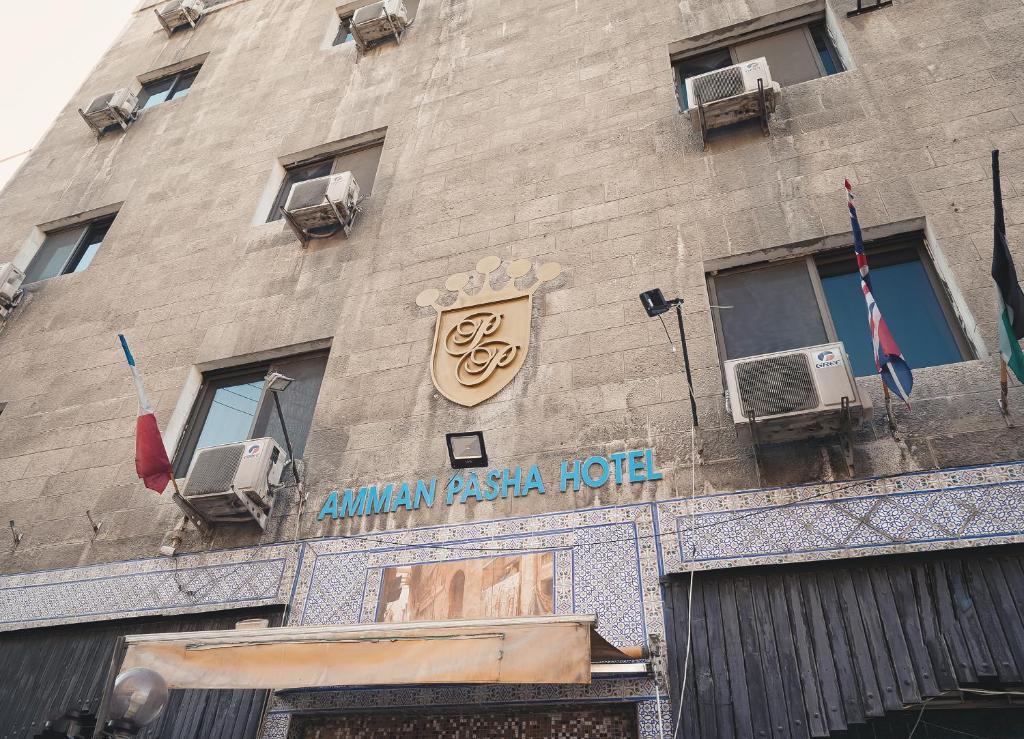 a building with a hotel sign on the side of it at Pasha Boutique Hotel in Amman