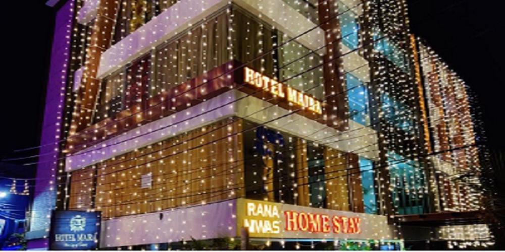 a large building with christmas lights on it at Hotel Maira in Dehradun