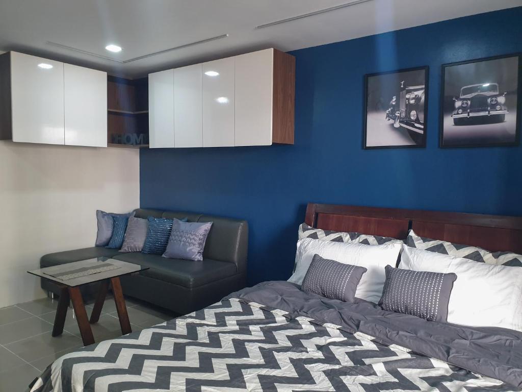 ein Wohnzimmer mit einem Bett und einem Sofa in der Unterkunft LaraHome City Living in Mandaue City