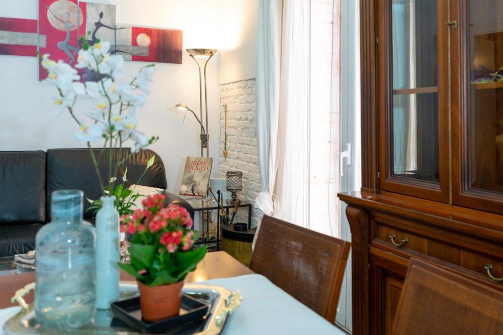 a living room with a table with flowers on it at modern and neoclassical flat in Madrid