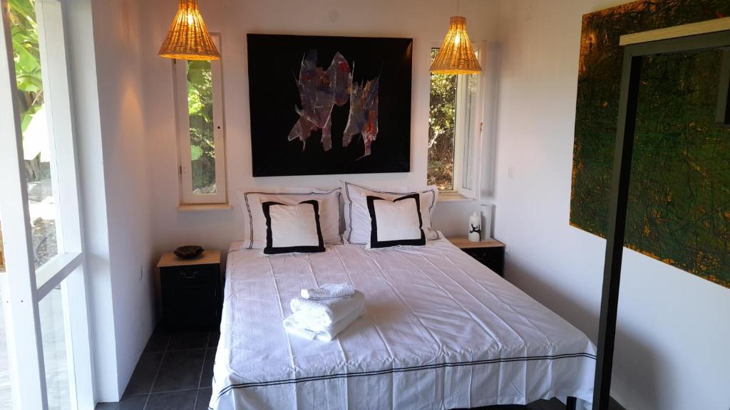 a bedroom with a large bed with two pillows at Greek Island bungalow in Samos set in beautiful nature in Samos