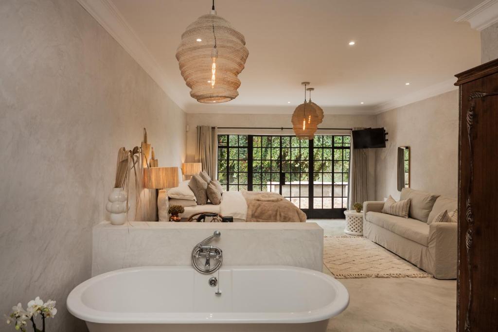 a bathroom with a sink and a living room at Viewpoint Estate Accommodation in Haenertsburg