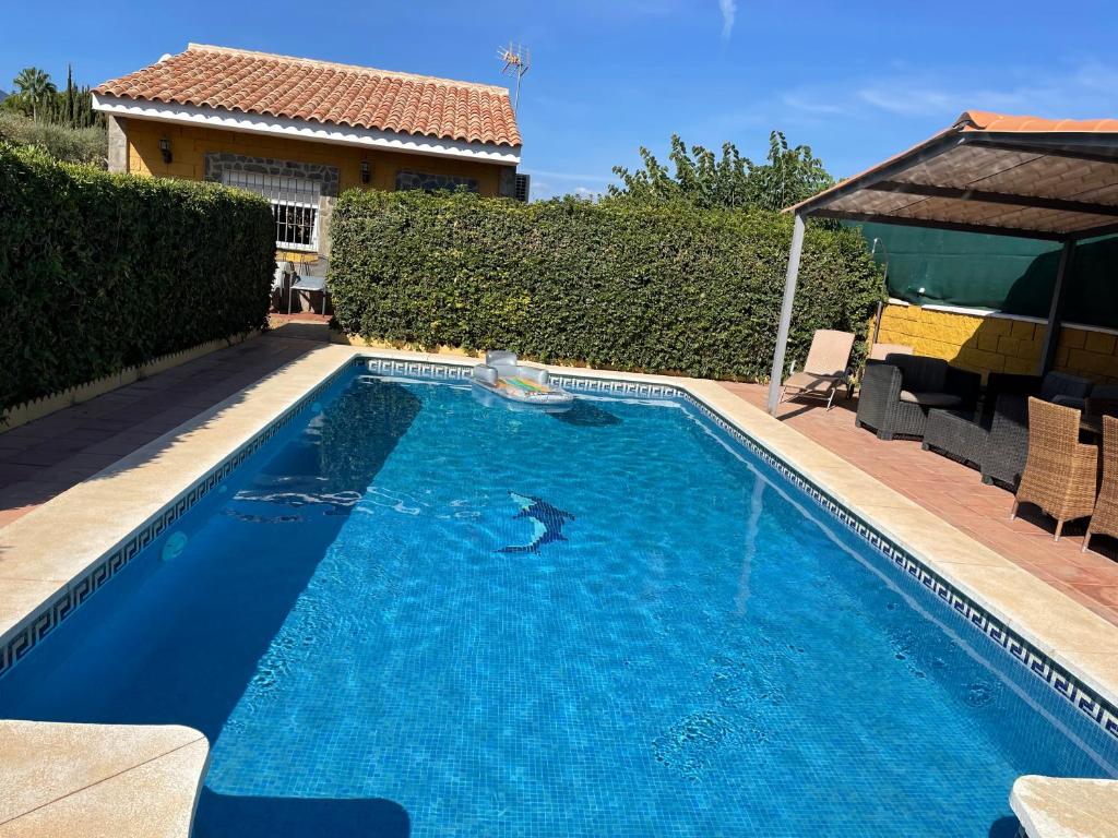 a swimming pool with a dolphin in the water at Villa Vanessa in Alhaurín de la Torre