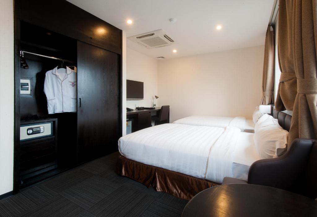 Postel nebo postele na pokoji v ubytování Sakura Hotel