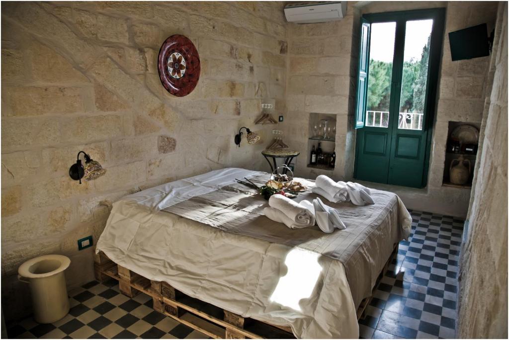 a bedroom with a bed with towels on it at Lazzarella B&B in Polignano a Mare