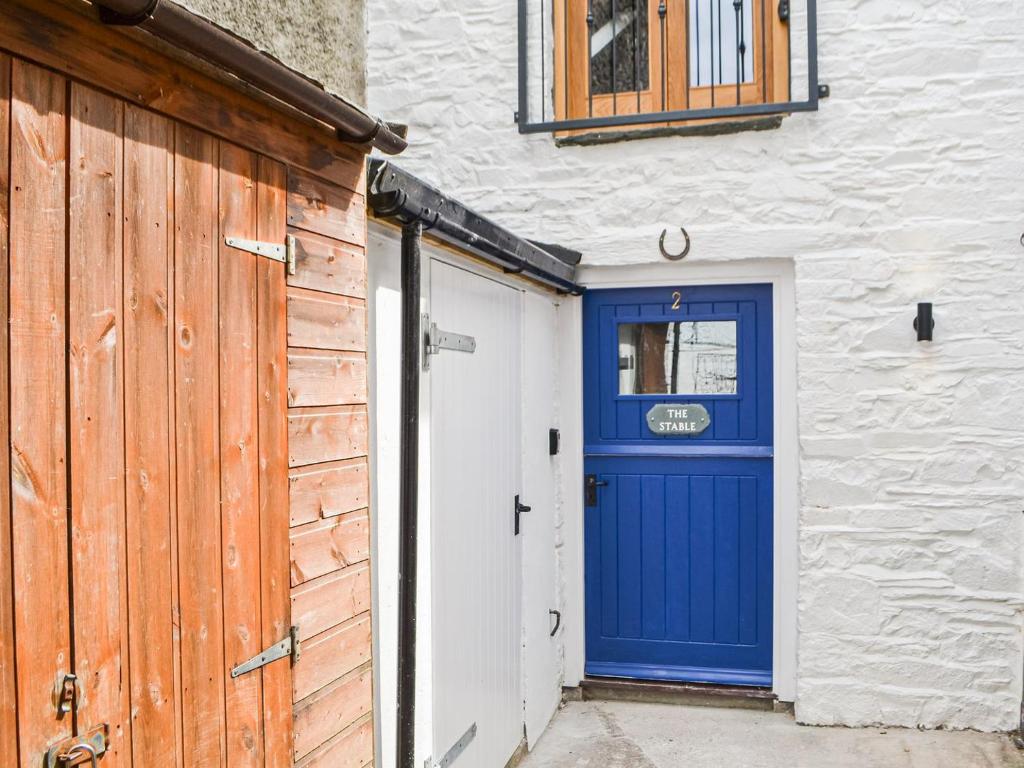 a blue door on the side of a building at The Old Stable in Keswick