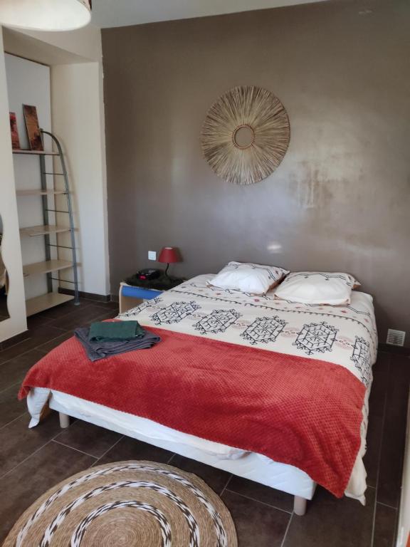 尼姆的住宿－Chambre privée avec parking，一间卧室配有一张带红色毯子的大床