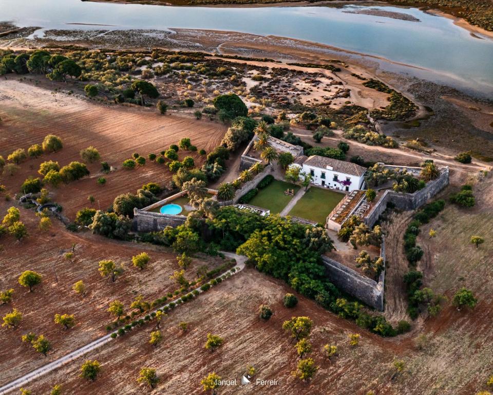 an aerial view of an island with a castle and the ocean at Forte De Sao Joao Da Barra in Cabanas de Tavira