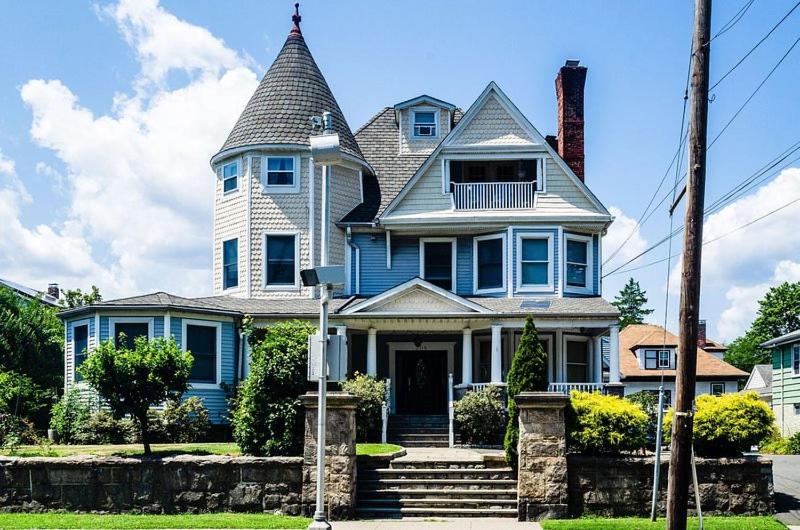 a large blue house with a tower on top at Farfalla Bianca in Mount Vernon