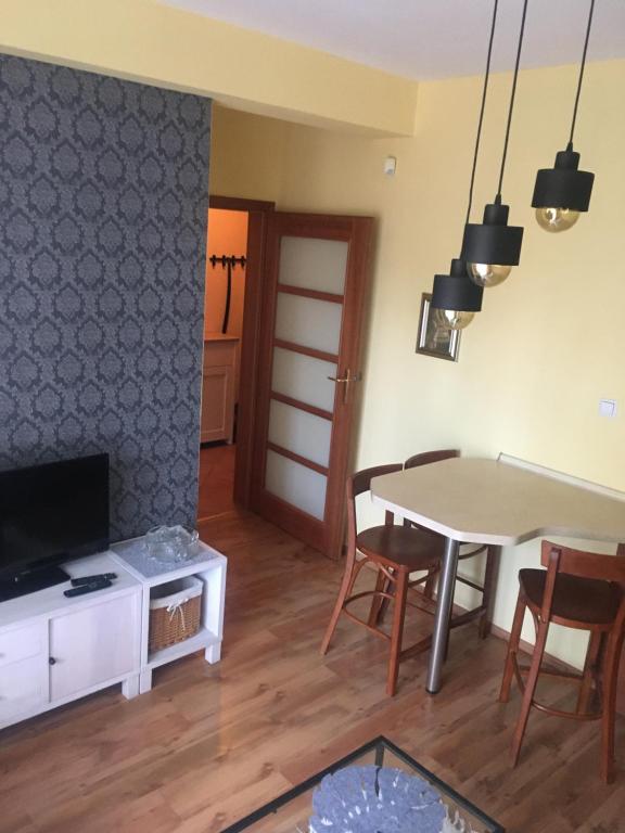 Televízia a/alebo spoločenská miestnosť v ubytovaní Apartament M