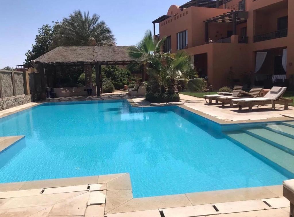 a swimming pool in front of a building at South Marina Apartment Wi-Fi available in Hurghada
