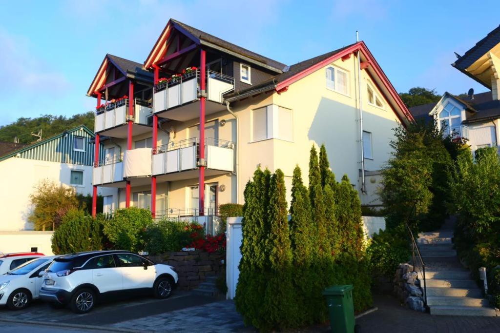 a white car parked in front of a building at Vakantiewoning EvaLisa in Willingen