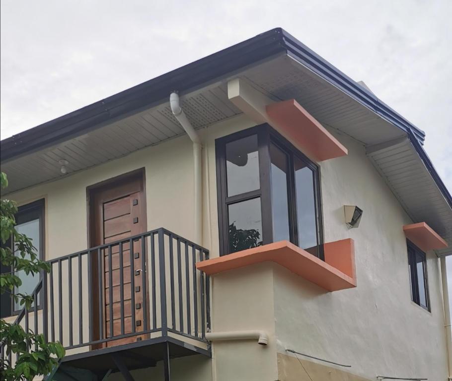 a small house with a balcony at EZ & V Guesthouse in Pagsanjan