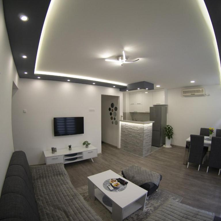 a living room with a couch and a table at Apartman Amor Trebinje in Trebinje