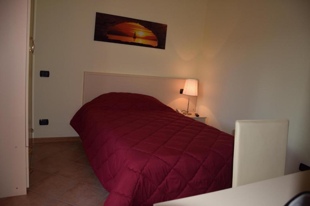 Łóżko lub łóżka w pokoju w obiekcie Hotel Il boschetto