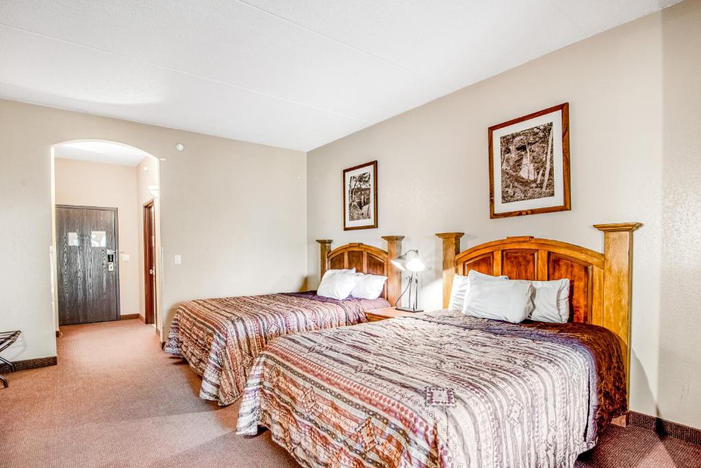 a hotel room with two beds and a hallway at Chula Vista Condo Unit 2647 in Wisconsin Dells