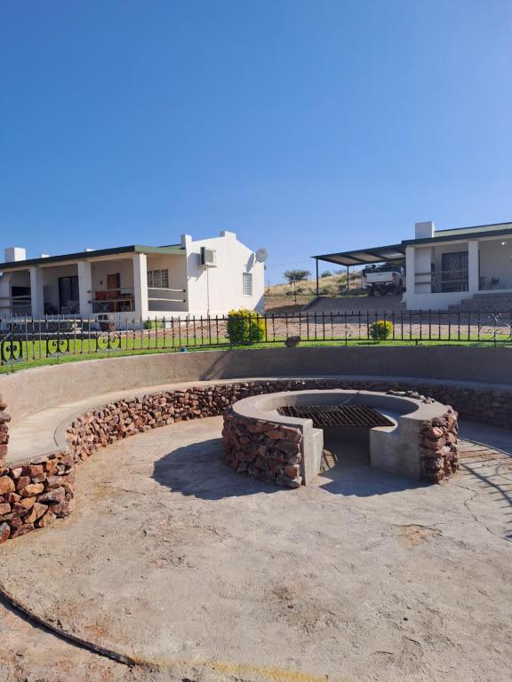 a fire pit in the middle of a yard at Sterrenhemel Guest Farm in Upington