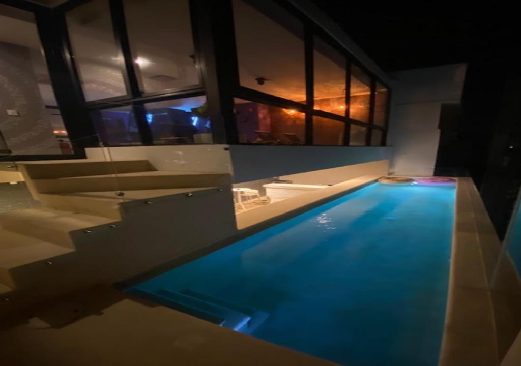 a swimming pool in the middle of a house at Auténtico Vertical Playa del Carmen in Playa del Carmen