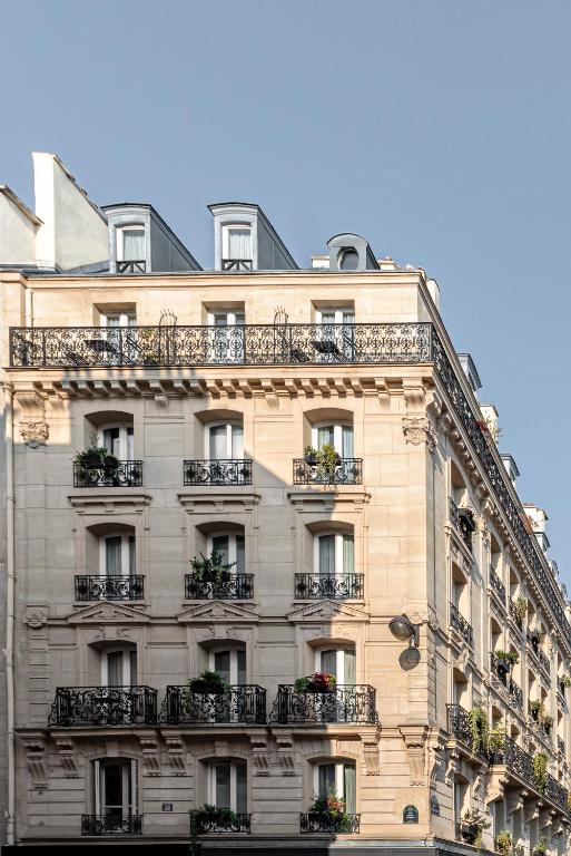 a building with balconies on the side of it at Grand Pigalle Hotel in Paris